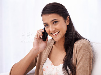 Buy stock photo Happy woman on couch with phone call, relax and conversation with mobile connection in apartment. Indian girl sitting on sofa with smile, talking on cellphone and communication for networking in home