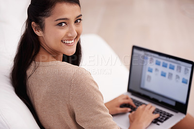Buy stock photo Portrait of woman on sofa with laptop, smile and relax with remote work, website and browse in living room. Happy girl on couch with computer for freelance job, online research and internet in home.