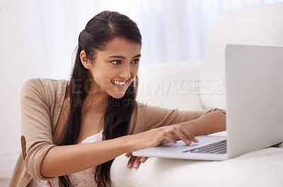 Buy stock photo Portrait of girl on sofa with laptop, smile and relax with remote work, website and browse in living room. Happy woman on couch with computer for freelance job, online research and internet in home.