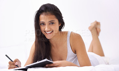 Buy stock photo Woman, bed and writing portrait in the morning with diary and book in a home with a smile. Indian female person, bedroom and wake up on duvet with peace and calm in a house on a blanket with comfort