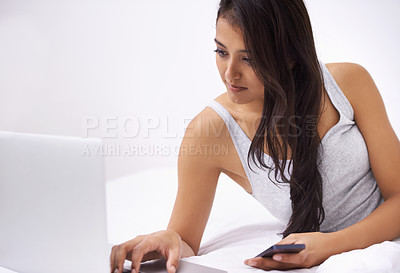 Buy stock photo Woman, laptop and phone on bed for planning, reading website and research of home education or e learning. Young person or student relax in bedroom with computer, mobile and social media or studying