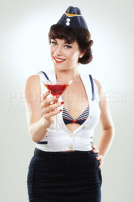 Buy stock photo Portrait, stewardess and happy woman with alcohol to drink in studio isolated on white background. Face, martini cocktail glass and air hostess with service, travel and vintage pin up girl on journey