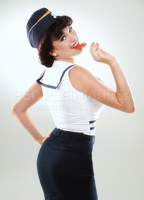 Buy stock photo A sailor pinup girl posing against white with a lollipop