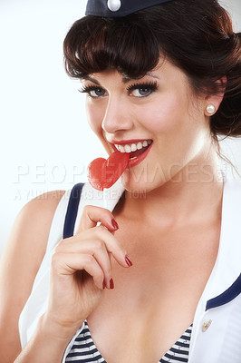Buy stock photo Portrait, smile of woman and sailor with candy in studio isolated on a white background. Face, lollipop and happy air hostess with sugar food, heart sweets and travel dessert for vintage pin up girl