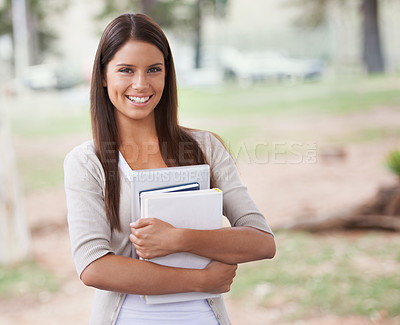 Buy stock photo A beautiful young student standing outside holding her books