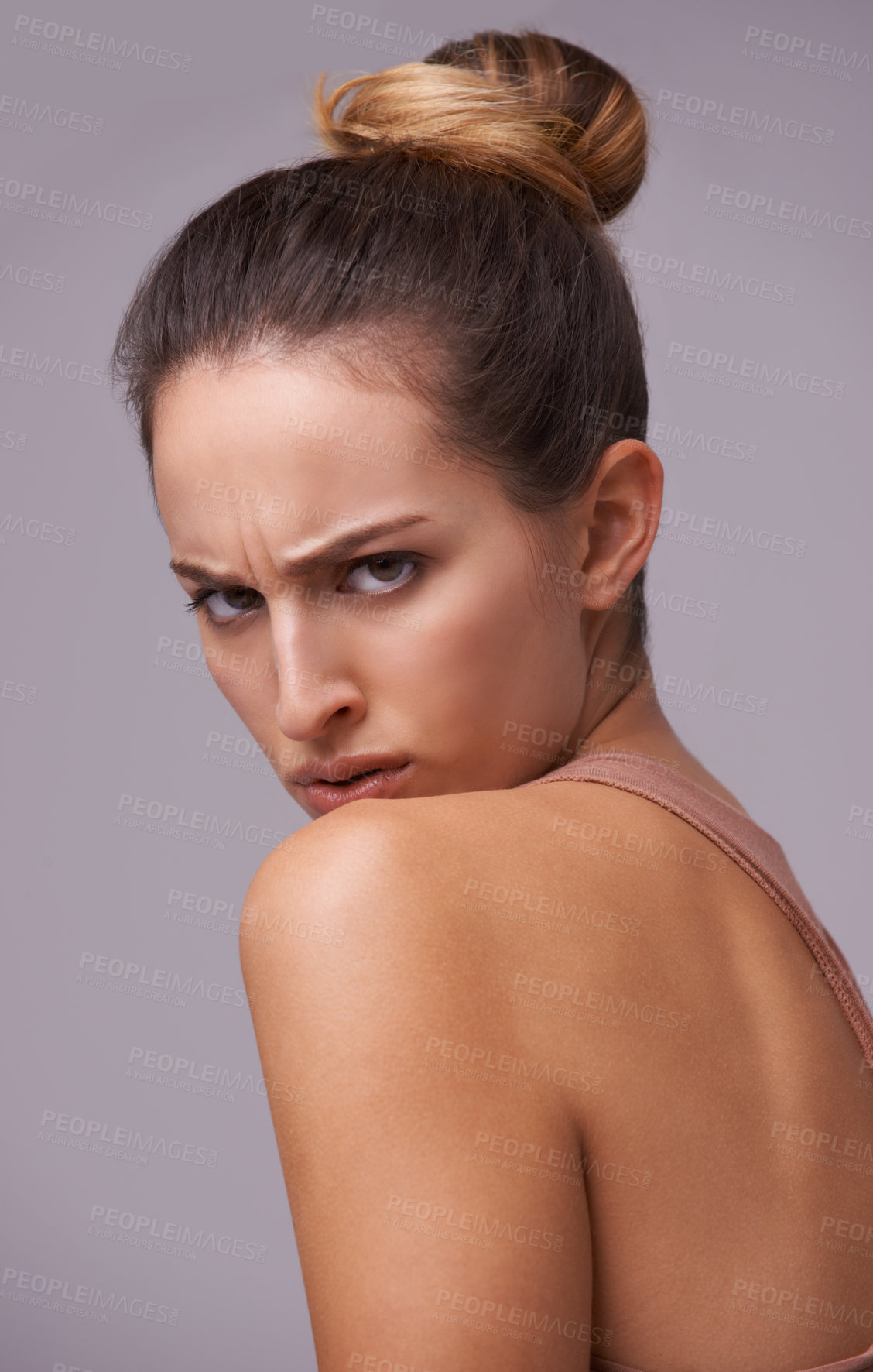 Buy stock photo An attractive young woman against a purple background