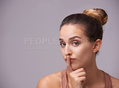 Buy stock photo Portrait of woman, finger on lips or silence for secret, mystery or privacy in gossip on grey background. Mouth, natural face or confident model isolated in studio with beauty for skincare or hush