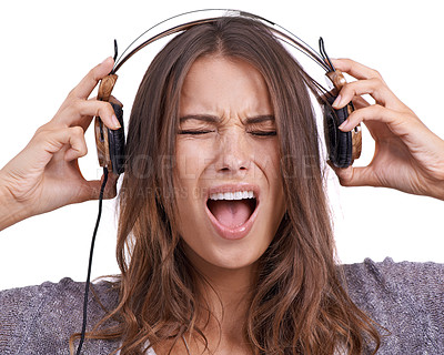 Buy stock photo Woman in studio with headphones, noise and scream in pain with feedback, sound or audio. Face of angry girl listening to music, podcast or streaming service online with technology on white background