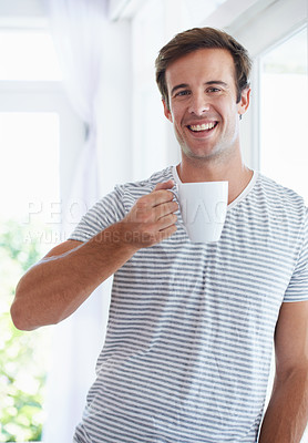 Buy stock photo Man, portrait and drinking coffee for relaxing at home, hot tea and beverage for positive attitude. Morning routine, male person and happy in apartment, smile and satisfied with matcha for enjoyment