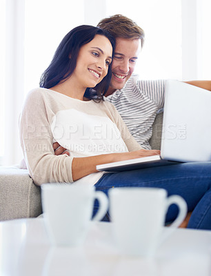 Buy stock photo Couple, laptop and watch movies on sofa with love, living room and wellness in marriage for bonding. Woman, man and smile for relationship care on subscription, weekend and streaming video in home