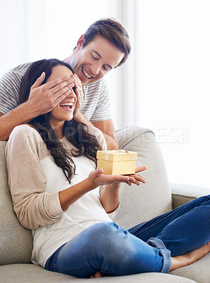 Buy stock photo Surprise, cover eyes or couple with present in home for love or playful in marriage with anniversary in lounge. Man, hands or woman for gift in relationship, care together or celebrate in apartment