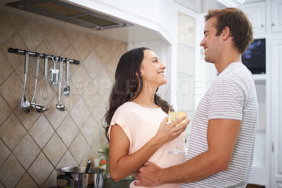 Buy stock photo Couple, hug and wine for cooking in kitchen, healthy meal and preparing food for eating at home. Happy people, alcohol and bonding together in marriage, nutrition and embrace for support and romance
