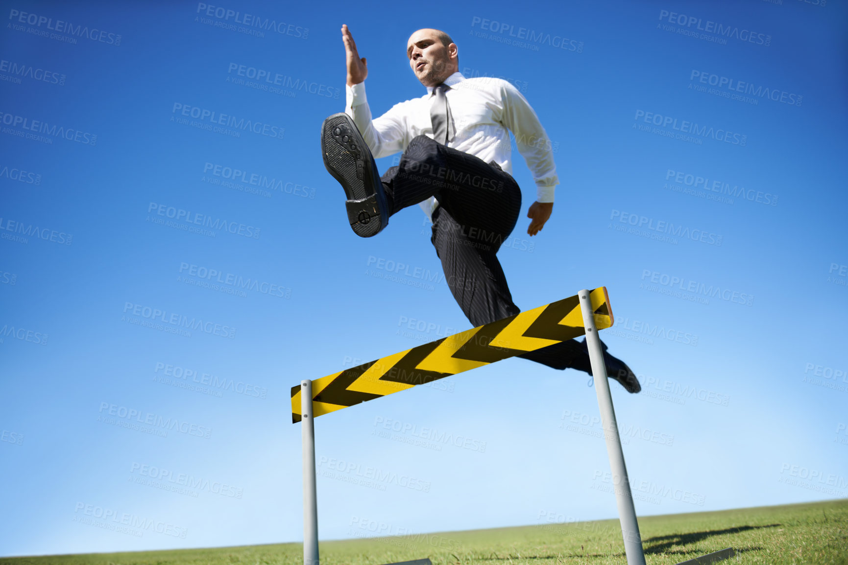 Buy stock photo Businessman, hurdle and jumping for career obstacle or competition or employee challenge, growth or achievement. Male person, leap and work professional goals for overcome, job development or mockup