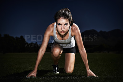 Buy stock photo A young woman at the starting line of a race