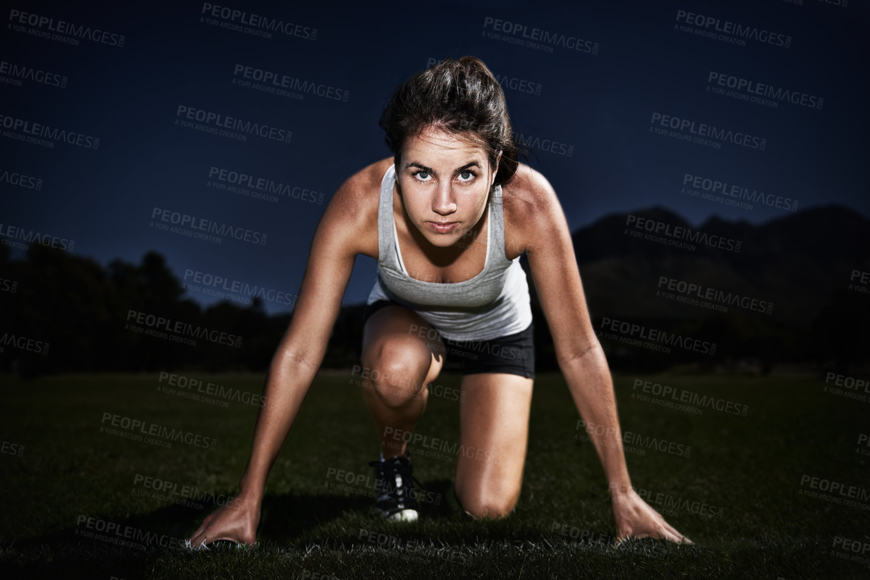 Buy stock photo A young woman at the starting line of a race
