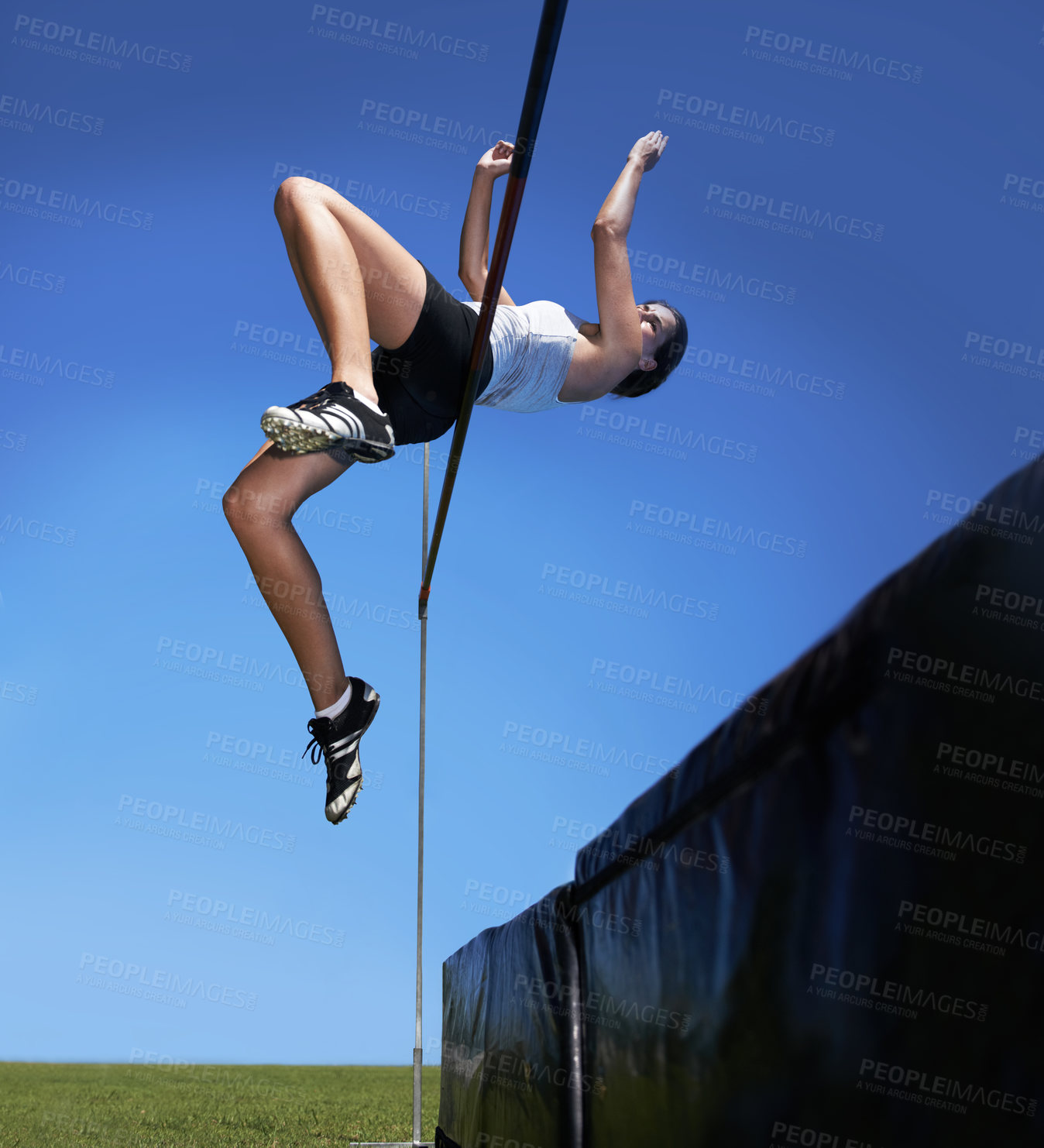 Buy stock photo Woman, high jump and athlete leap for sport training outdoor for competition, endurance or practice. Female person, workouts and agility for cardio exercise or contest fitness, blue sky or flexible