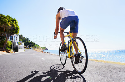 Buy stock photo Fitness, street and man cycling on bicycle, morning trip or journey for outdoor sports, exercise or workout. Back, travel and cyclist on bike for cardio, activity or training for summer triathlon