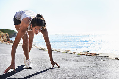Buy stock photo Woman, fitness and starting line by beach for running, workout or sprint in outdoor exercise. Active young female person getting ready for run, lap or cardio training on asphalt road by ocean coast