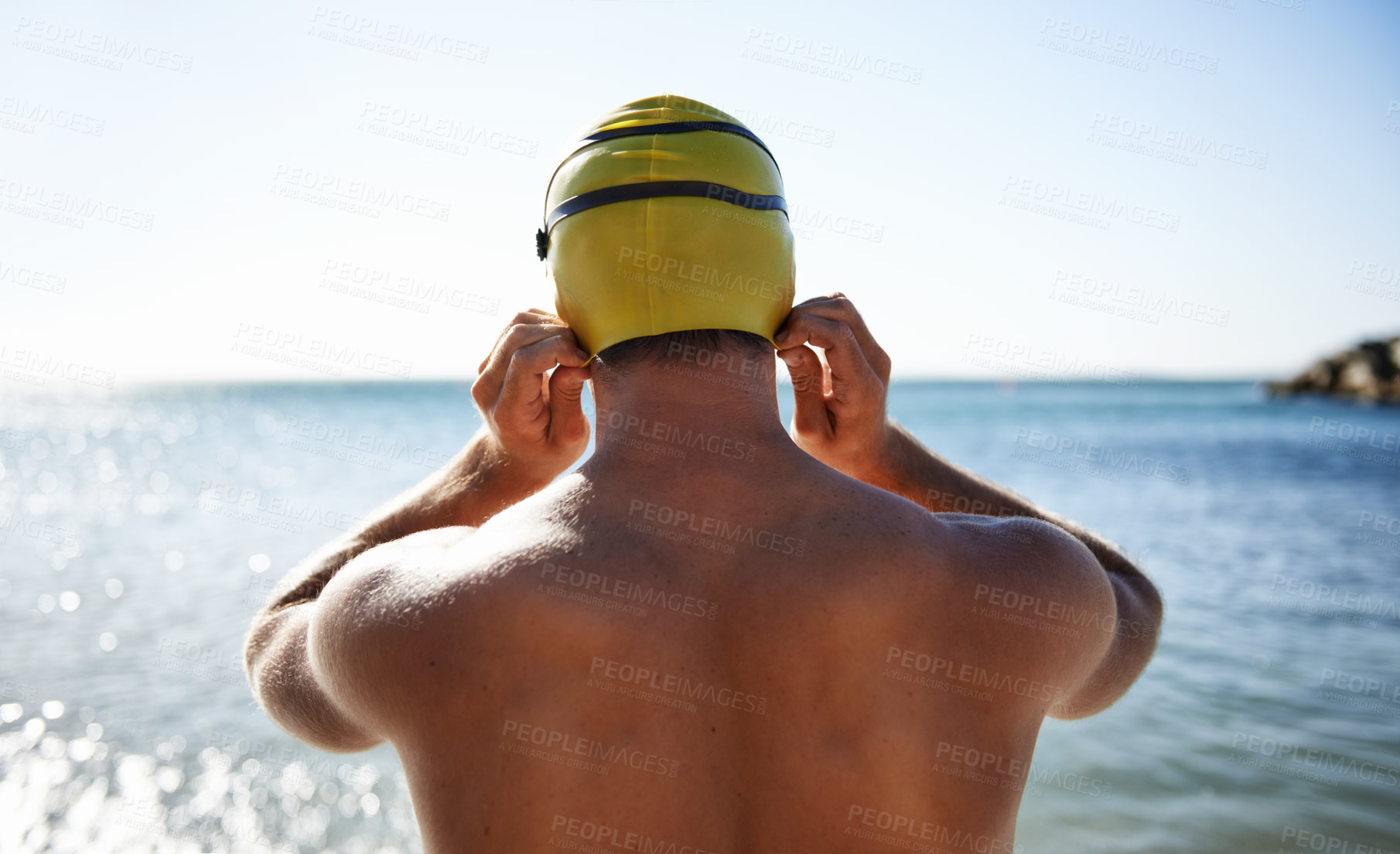 Buy stock photo Sports, ocean and back of man for swimming exercise, workout or training in beach, nature or water. Back, swimwear cap and athlete ready to start challenge, fitness contest or practice for triathlon