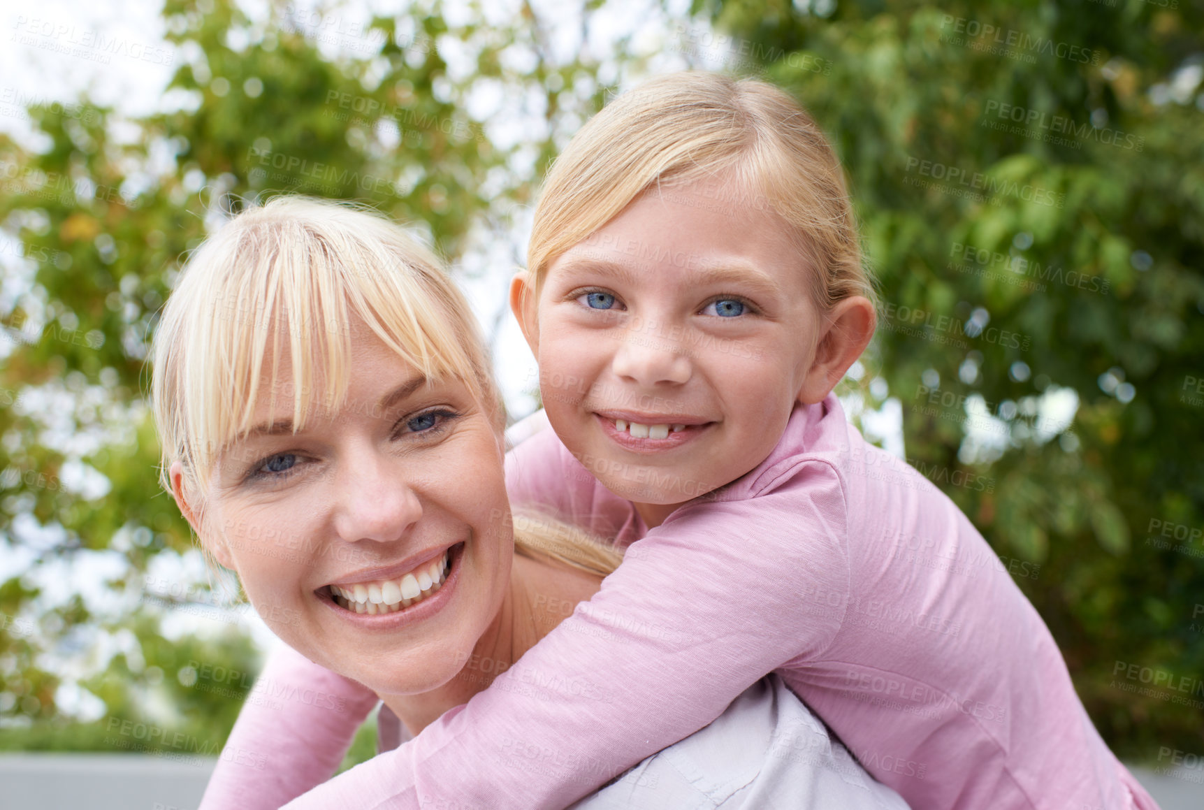 Buy stock photo Nature, piggyback and portrait of mom with kid playing in an outdoor park, garden or field. Love, smile and happy young mother having fun, bonding and carrying cute girl child outside in summer.