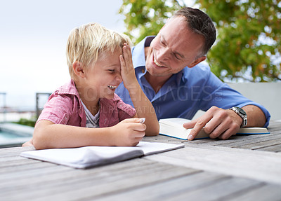 Buy stock photo Laughing, homework and dad with son at table in backyard for child development, knowledge and studying. Education, books and help, father and kid on patio with notebook for learning, fun and drawing.