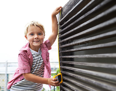 Buy stock photo Smile, measuring tape and portrait child doing maintenance on wood gate for fun or learning. Happy, equipment and young boy kid working on repairs with tool for home improvement outdoor at house.