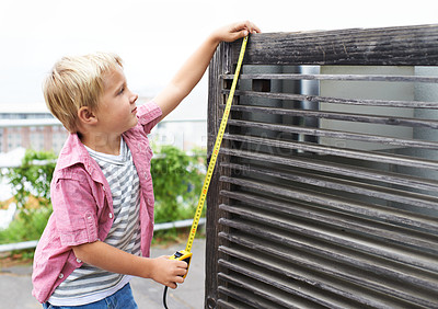 Buy stock photo Cute, measuring tape and portrait child doing maintenance on wood gate for fun or learning. Happy, equipment and young boy kid working on repairs with tool for home improvement outdoor at house.