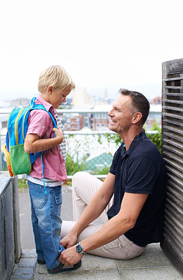 Buy stock photo A father helping his son get ready for school