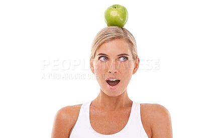 Buy stock photo Woman, wow and apple on head in studio for wellness, diet and balance by white background. Isolated model, fruit and surprise expression face for vitamin c, natural nutrition and healthy organic food