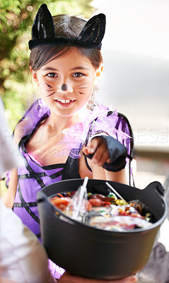 Buy stock photo Portrait, halloween and girl child with candy in costume for trick or treat tradition on holiday. Vacation, youth and bucket of sweets with young kid at door of home for fall holiday celebration
