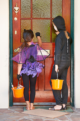 Buy stock photo Halloween, back and children knocking on door for trick or treat together in spooky holiday costume. Friends, fantasy or candy with kids on porch of home for tradition as brother as sister siblings