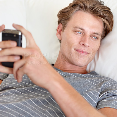 Buy stock photo Thinking, phone and man relax on a sofa with social media, chat or texting while streaming in his home. Smartphone, daydreaming and male person search for online dating, meme or web subscription
