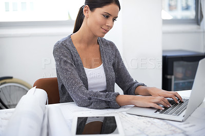 Buy stock photo Woman, laptop and floor plan for architecture research, design planning and software in a startup office. Young engineering worker or designer typing on computer with blueprint documents for project