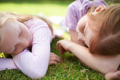 Buy stock photo Sleeping, children or girl siblings on grass for bond or calm peace together with eyes closed. Resting, tired kids or sisters on outdoor break with care, love or friendship in park, garden or nature