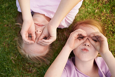 Buy stock photo Hands, binocular or girl sisters in park for bond, holiday or play together for support or joy. Top view, relax or funny children siblings in field with games, freedom or friendship in a garden