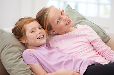 Buy stock photo Girl children, sisters and couch portrait, bonding with love and care at family home, trust and support. Friends, smile and time together in living room, relax on sofa with happiness and hug