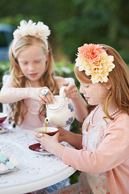 Buy stock photo Girl, friends and tea party in garden or dessert snack happy for dress up game, fantasy or playing. Female people, siblings and pot for hot drink in backyard for summer event fun, lunch or birthday