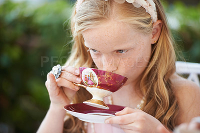 Buy stock photo Girl, kid and drinking tea in garden with party for birthday, celebration and playing outdoor in home. Person, child and porcelain cup in backyard of house with dress up, beverage and role play fun