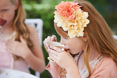 Buy stock photo Girl, child and drinking tea in garden with party for birthday, celebration and playing outdoor in home. Person, kid and porcelain cup in backyard of house with dress up, flower and role play fun