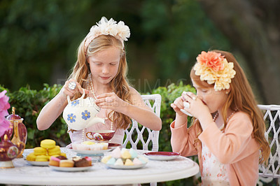 Buy stock photo Girls, children and tea party or outdoor fun for fantasy play in garden for cake snack, birthday or game. Kids, sisters and fancy dress up in nature or summer bonding in backyard, beverage or dessert
