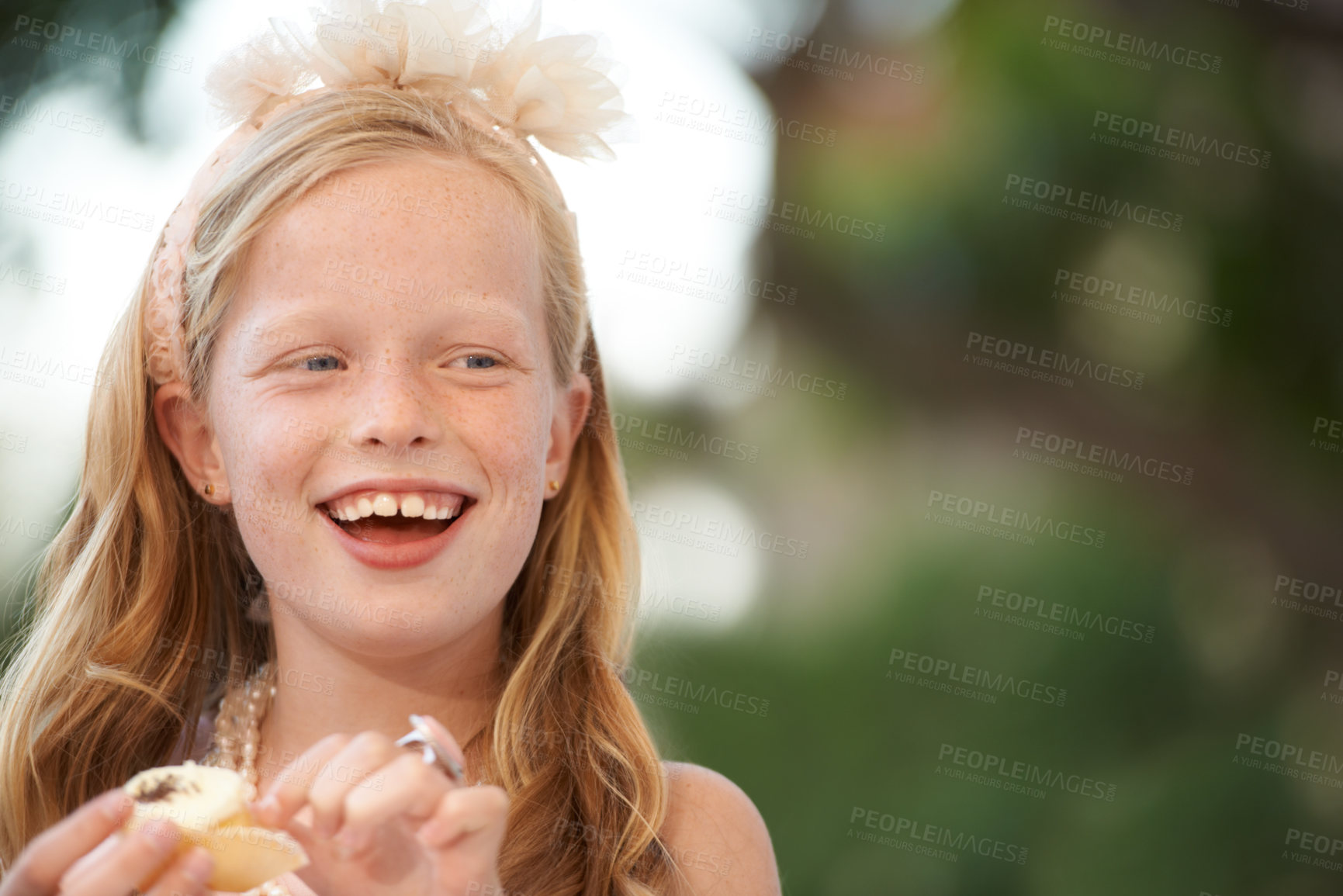 Buy stock photo Child, girl and eating cupcake or outdoor smile for birthday food or celebration, dessert or candy. Female person, happy kid and sweet snack at garden event for hungry joy or treat meal, party or fun