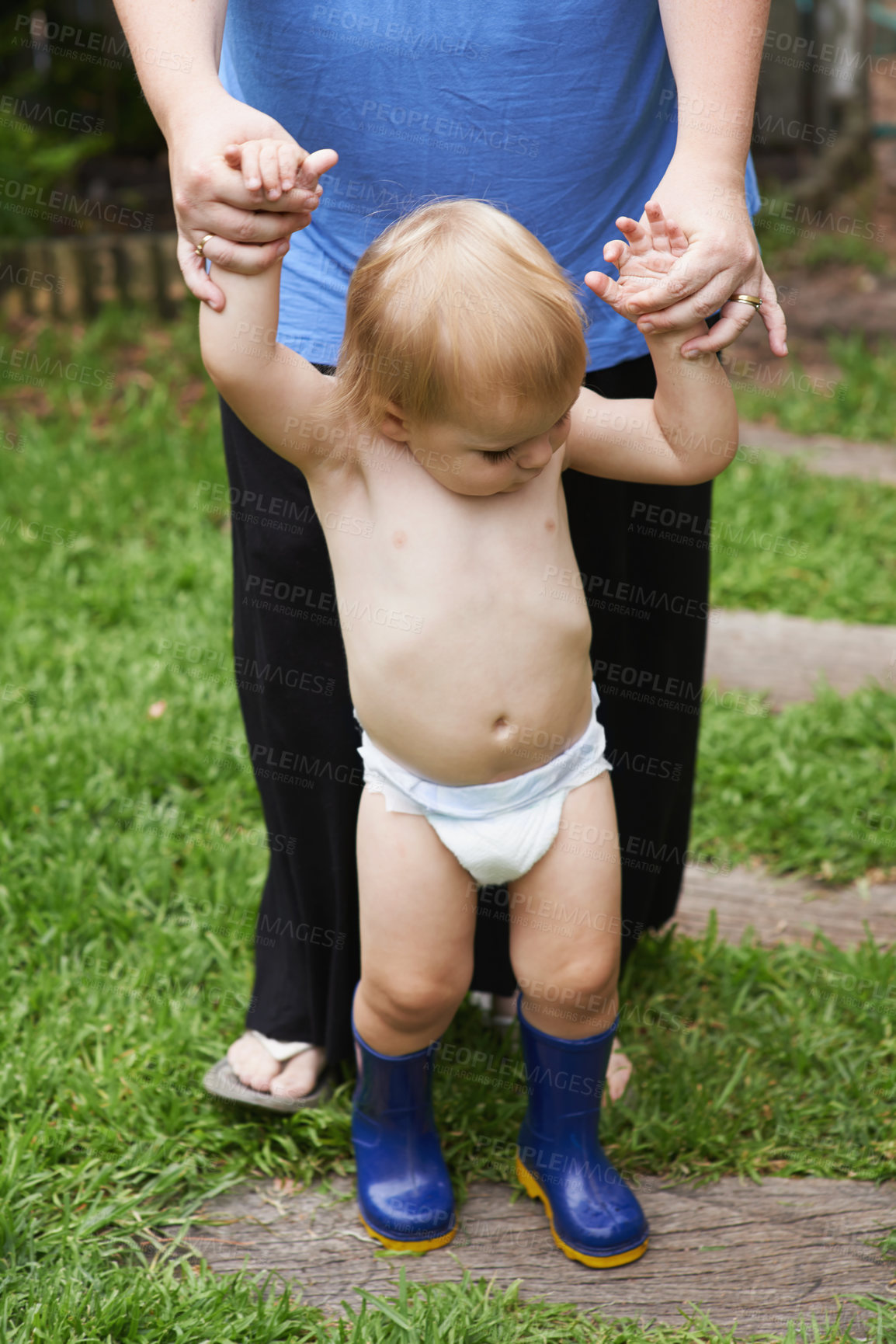 Buy stock photo Baby, first steps and parent in outdoor, development and growth for curiosity, backyard and home. Toddler, child and face in garden, alone and childhood memories for wellness, milestone and exploring