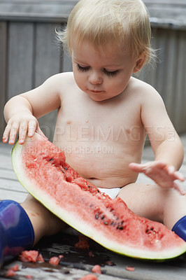 Buy stock photo Baby, playing with watermelon and eating, backyard and  development with growth, curiosity and home. Toddler, child and infant in garden, alone and childhood for wellness, milestone and coordination