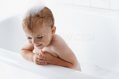 Buy stock photo Happy baby in bathtub, cleaning and bubbles on mockup in morning routine for hygiene, wellness and body care in home. Cute toddler washing in foam with smile, relax and calm child in tub in bathroom.