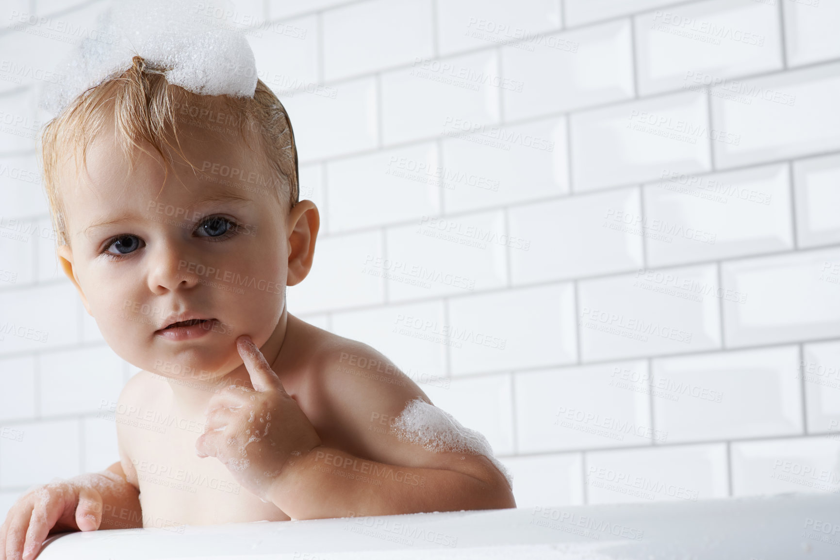 Buy stock photo Portrait of baby in bath with soap, bubbles and cleaning on mockup in morning for hygiene, wellness or care in home. Toddler washing in foam with face, relax and face of calm child in tub in bathroom