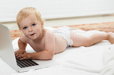 Buy stock photo Baby, playing and learning on laptop in portrait on bed at home with online games for education. Happy, child and relax with cartoon, movies or development of knowledge of technology for growth
