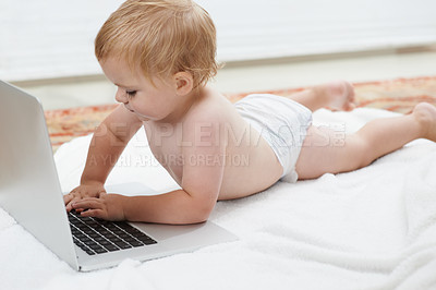 Buy stock photo Baby, playing and learning on laptop in home on bed with online games for education. Child, typing and relax with cartoon, movies or development of knowledge of technology with elearning for growth