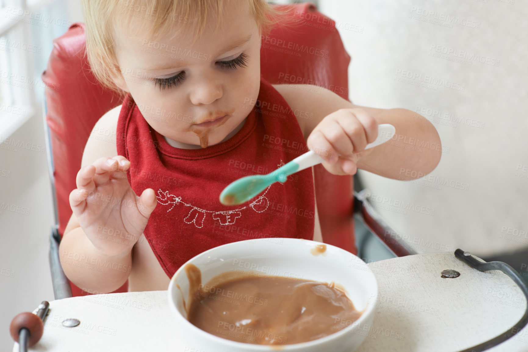 Buy stock photo High chair meal, baby and eating spoon in a house with diet, nutrition and child, wellness or  development. Food, messy eater and boy kid curious about breakfast cereal, playing or learning at home