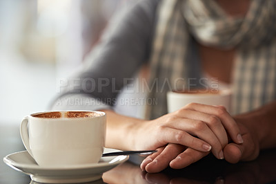 Buy stock photo Cropped shot of a couple sitting in a coffee shop