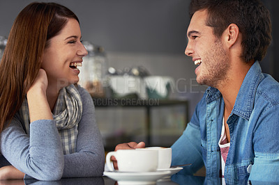 Buy stock photo A loving young couple at a coffee shop together